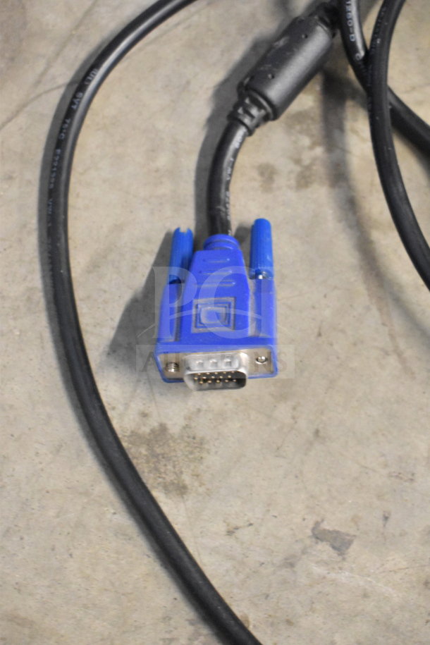 A blue VGA cable connector on a concrete surface.