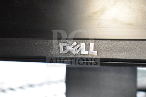 Four monitors including Dell and HP. Features visible Dell logo. Auction includes four screens.