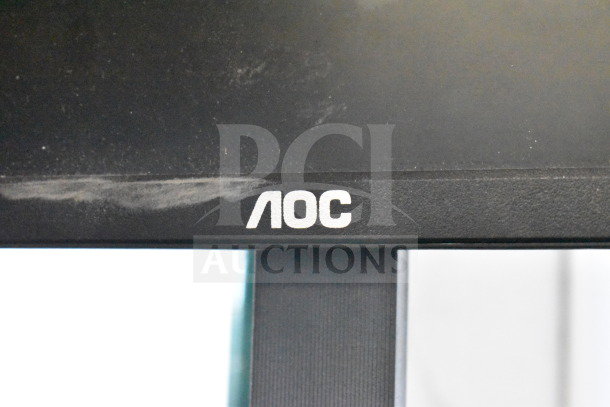 Four monitors including Dell and HP, with visible AOC logo. Light signs of use. Ideal for expanding screen setups.