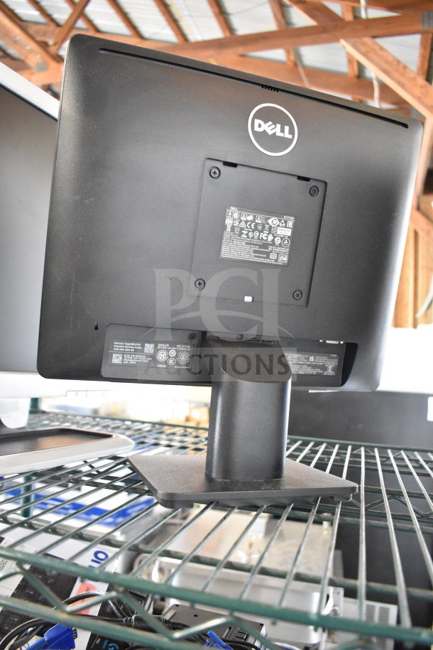 Dell monitor rear view with stand; part of a lot of four monitors including Dell and HP, showing ports and labeling details.