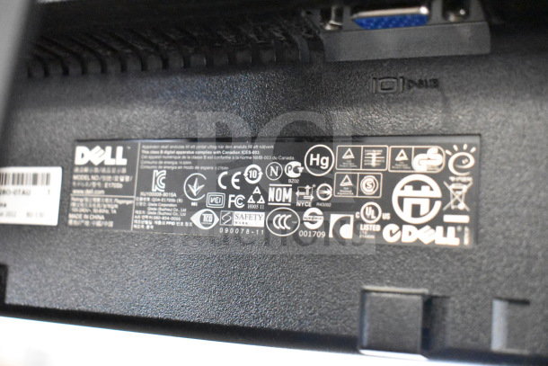 Four monitors, including Dell and HP brands. Dell monitor model E170SB shown with safety and compliance labels.