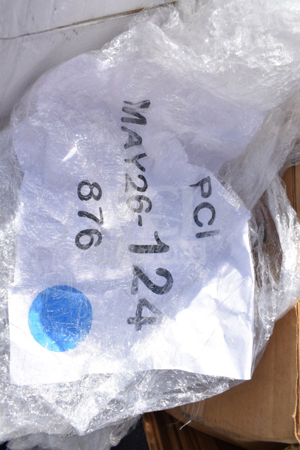 Plastic-wrapped pallet marked "MAY26-124." Contains 27 new scratch and dent items like plates, cutlery, trays, and cups.