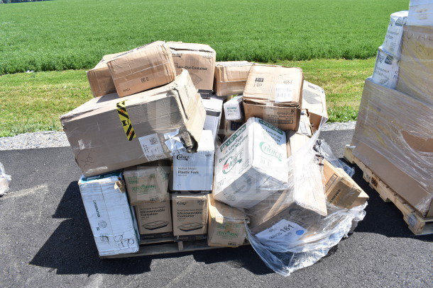 Boxes labeled with plastic forks, plates, cups, and more, visibly dented and stacked on pallets. Marked "MAY26-161."
