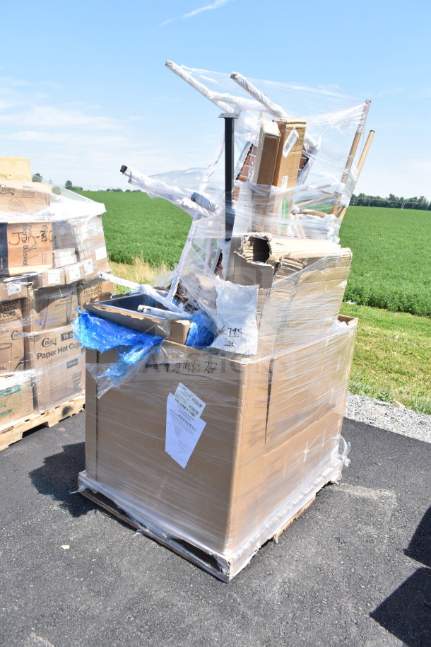 Pallet of mixed scratch and dent items, including chairs, wrapped in plastic. Visible tags and labels indicate condition.
