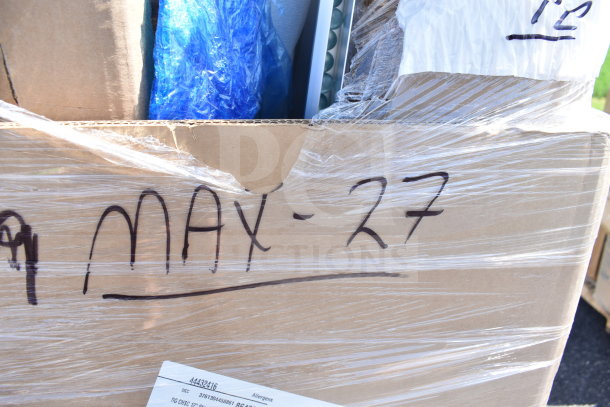 Large cardboard box labeled "MAY-27" containing 11 brand new items, including chairs. Box wrapped in plastic.