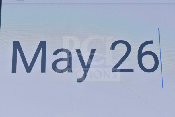 Close-up image showing text "May 26." Relevant to lot of new scratch and dent items including chair and dish dolly.