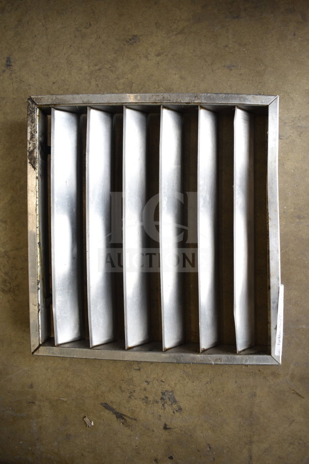 Metal vent cover with seven slats, displaying a robust, industrial design. Slight wear visible on the metal surface.
