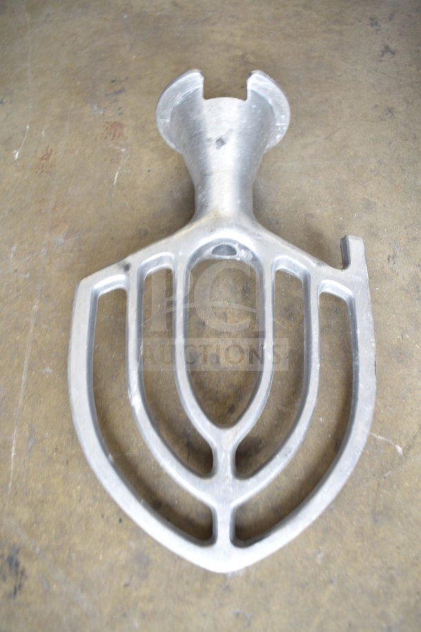 Metal paddle attachment for mixer, used, in good condition. Framed blade design with central opening, no brand markings.