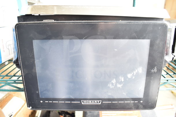 2017 Hobart HTi-7LH26 commercial countertop scale, front screen non-functional, back screen operational, model label shown.