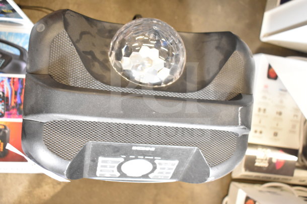 Ion Party Rocker Max Speaker on store display, features a disco ball, control panel, and textured speakers, in good condition.
