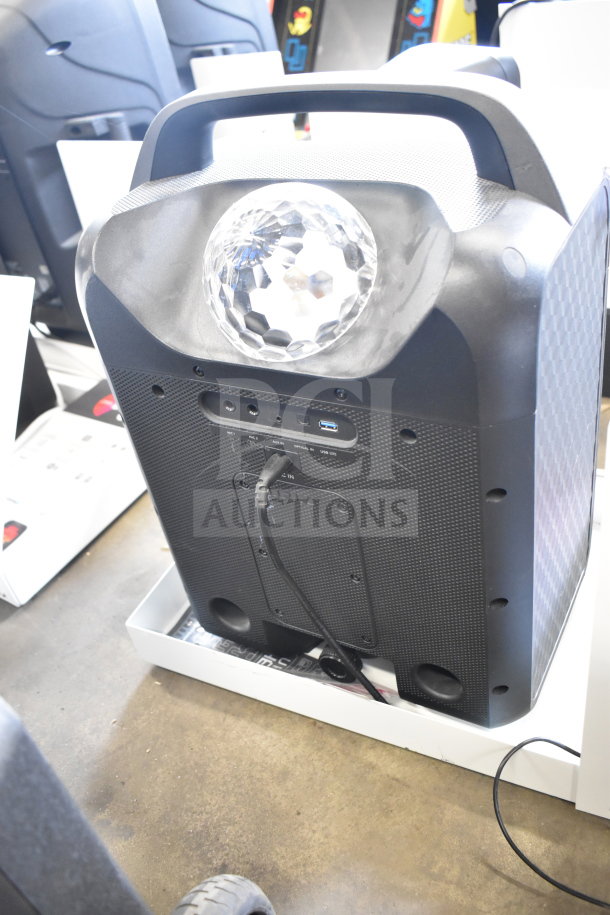 Ion Party Rocker Max speaker in store display. Black with LED light, connectivity ports, and handle. Used condition.