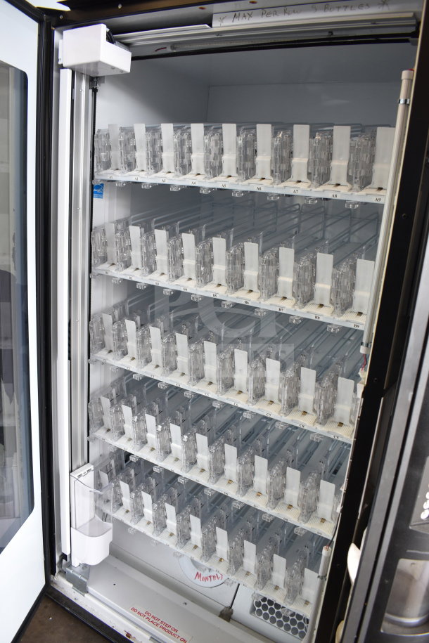 Crane 5800-4 commercial vending machine, 115 volts, 1 phase, with bill acceptor. Clean interior, visible product slots.