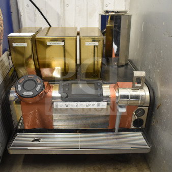 Thermoplan Mastrena stainless steel espresso machine with LCD display, hoppers labeled "Blonde," "Espresso," "Decaf," and steam wand.