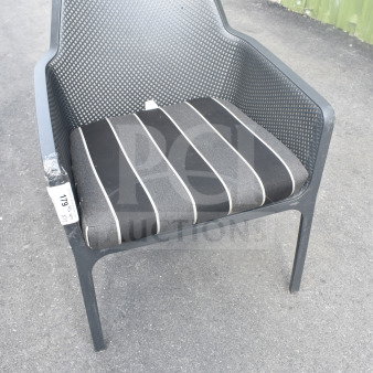 Black patio armchair with mesh back, featuring gray and black striped cushion. Tag reads "17G". Good condition.