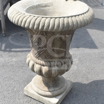 Ornate stone planter with ribbed lip and textured pattern, marked "Unique Stone © 2000." In well-preserved condition.