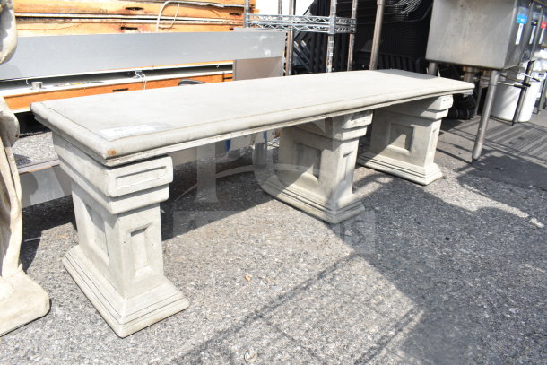Stone bench with rectangular seat and two pedestal supports. In good condition, suitable for outdoor use.