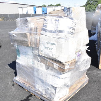 Plastic-wrapped pallet with new scratch and dent items, including plates, cutlery, trays, and cups; visible labels from Karat and others.