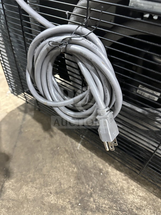 Coiled power cord for a Turbo Air TGM23SDW refrigerated display unit on a wire rack.