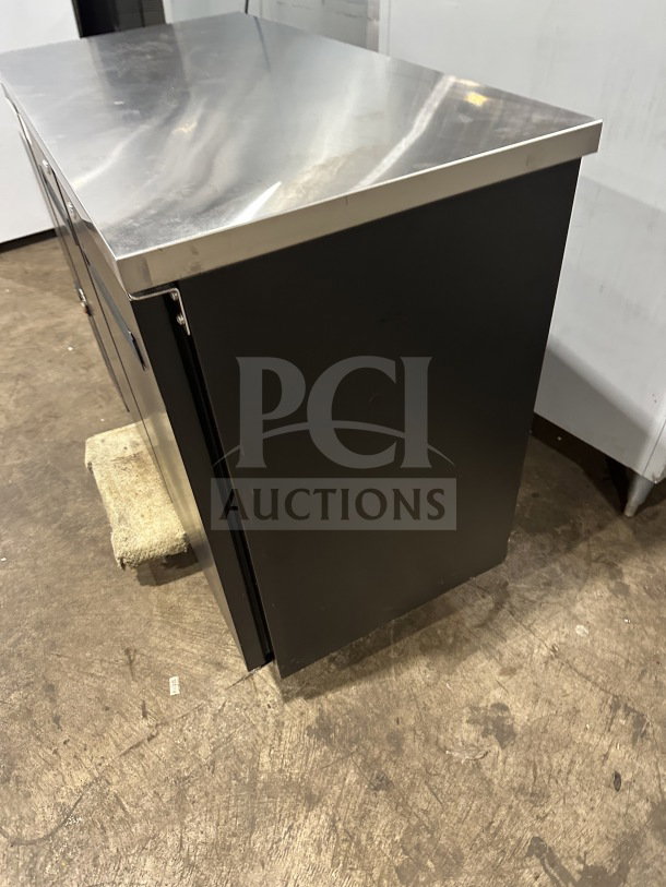 Brand new Avantco 48" black stainless steel countertop cooler, model 178UBB48HC, with poly-coated rack and swing doors.
