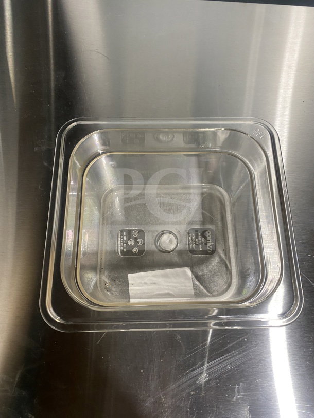 Brand new Winco SP7604 polycarbonate food pan, 1/6 size. Clear with visible product markings, in pristine condition.