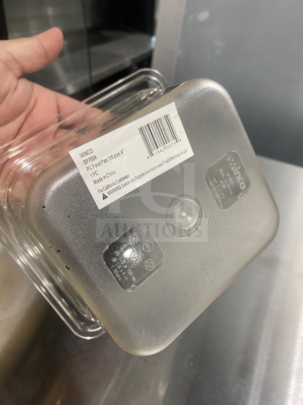 Brand new Winco SP7604 polycarbonate 1/6 size food pan. Visible label with model and serial number.