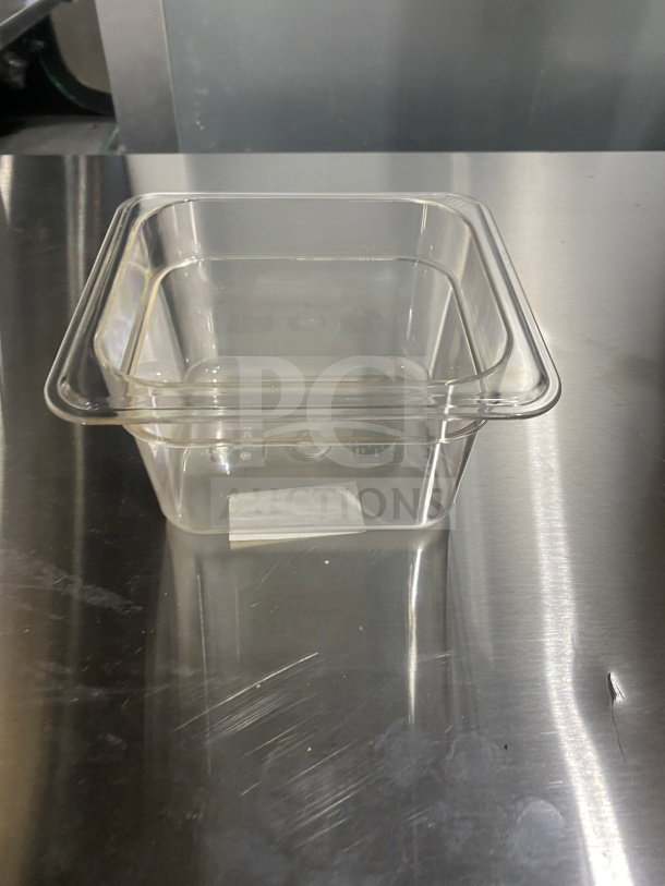 Brand new Winco SP7604 commercial polycarbonate 1/6 size food pan on stainless surface. Model: SP7604, SN: 811642002754.