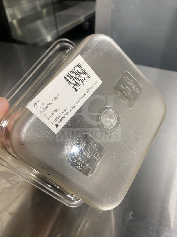 Brand new Winco SP7604 commercial polycarbonate food pan, 1/6 size. Model label and barcode visible.