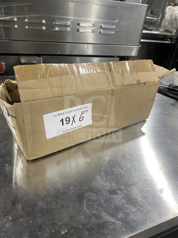 Cardboard box labeled "19X QTY" containing a Brand New Volrath Model 61172 4 Oz. Black Solid Round Stainless Steel Spoodle with Grip 'N Serve handle.
