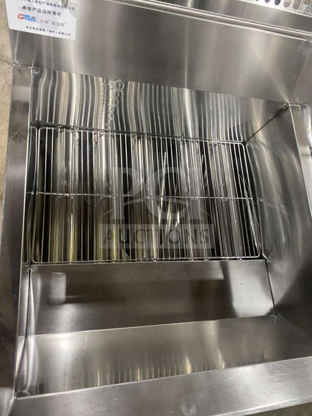 Brand new Gaoji Gorgeous Model MHGF2T46F stainless steel double tank deep fryer, gas-powered, on legs.