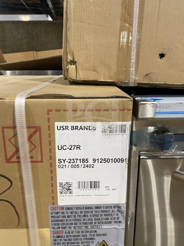 Brand new ColdLine UC-27R undercounter worktop refrigerator in box. Features stainless steel, electric-powered, with poly-coated wired rack, on casters. Model: UC-27R, SN: 745064364, 115V.