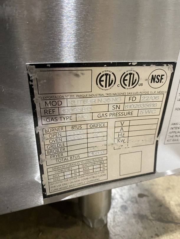 BRAND NEW Kutano 36" 6-Burner Range, Model KUT6BRN36NG. Stainless steel, natural gas, with oven, on legs. SN: 8102635618.
