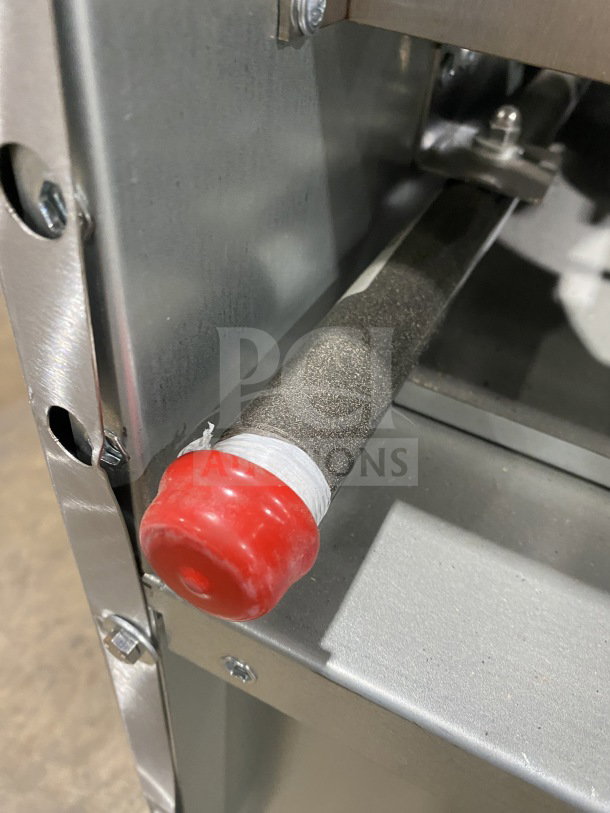 Close-up of a new Kutano KUT6BRN36NG range corner with red protective cap and stainless steel construction details.