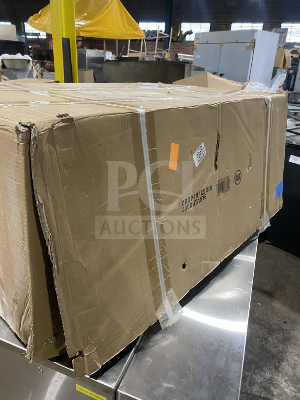 Brand new commercial stainless steel drop-in ice bin with sliding lid, model 600DIB1236, in original packaging.
