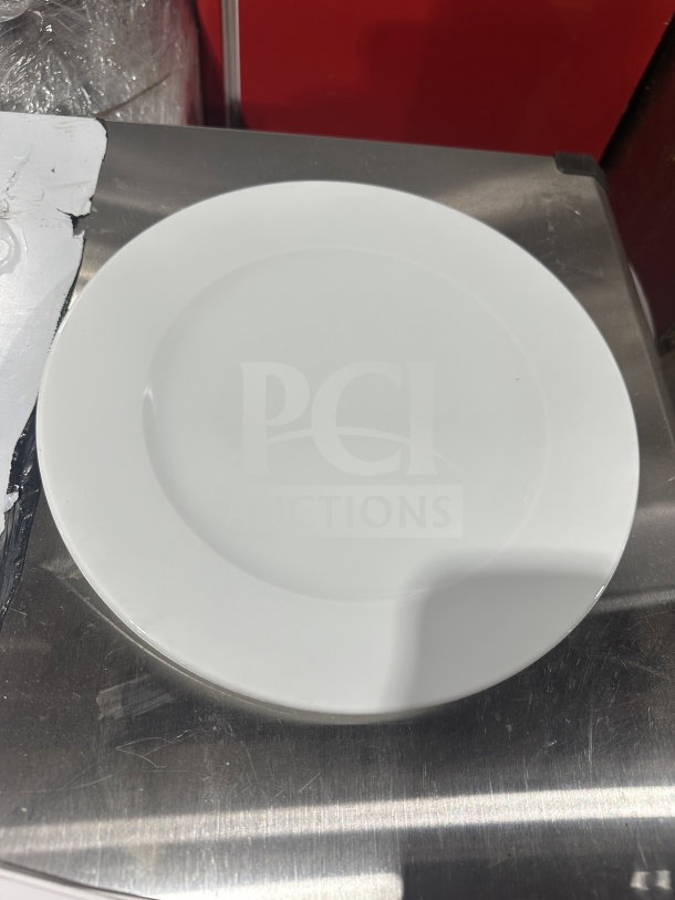 Brand new Turgla 11" round white porcelain dinner plate, model D128DU00, with rolled edge and wide rim.