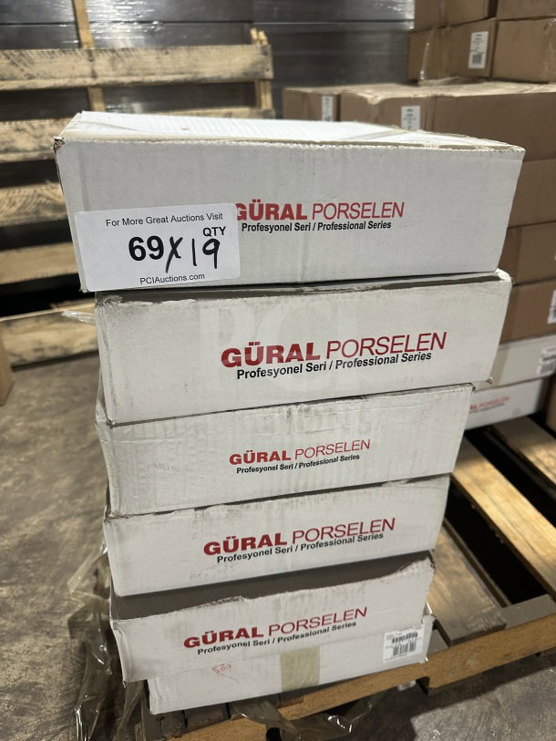 Stack of boxes labeled "Gural Porselen Professional Series" containing new 12.5" white porcelain plates, Model D132DU00.