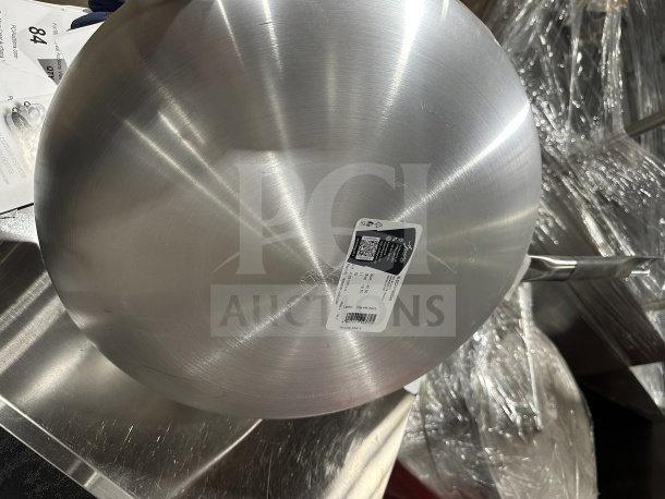 Brand new Pentole Agnelli stainless steel non-stick fry pan, commercial-grade, auction label visible, pristine condition.