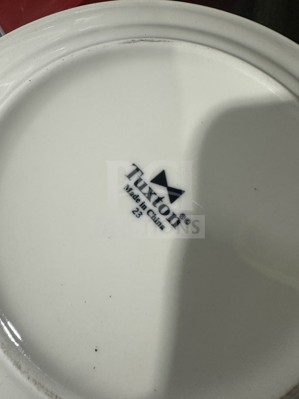 Brand new Tuxton 9" vitrified china dinner plate, model RFA-090, with logo and "Made in China" marking.
