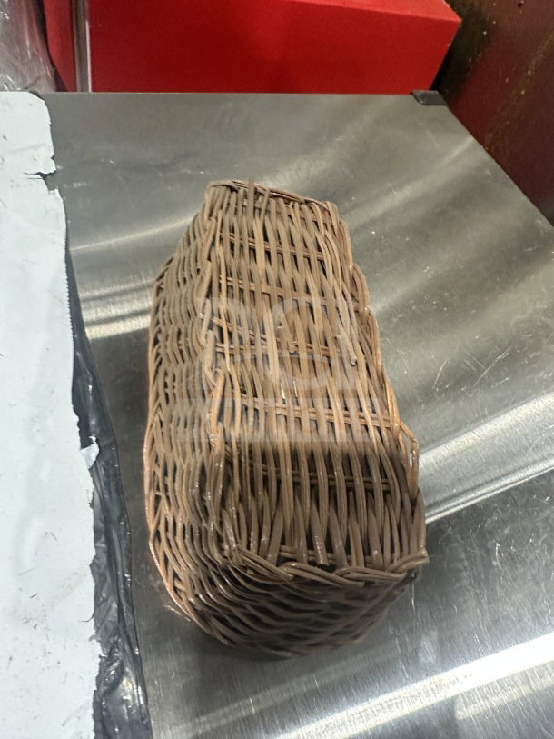 Brand new Browne woven polypropylene basket for food display, shown sideways. Durable, great for organizing snacks.