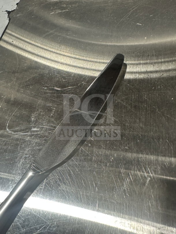 Brand new 9.25" stainless steel dinner knife, serrated edge, commercial quality, sold by the dozen.