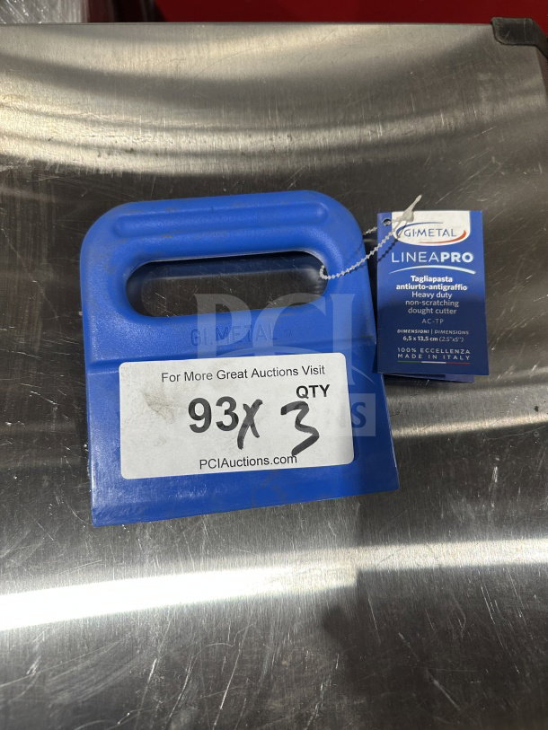 "Brand new GI Metal blue polymer dough cutter, model AC-TP, with tag indicating heavy-duty, non-scratching use."