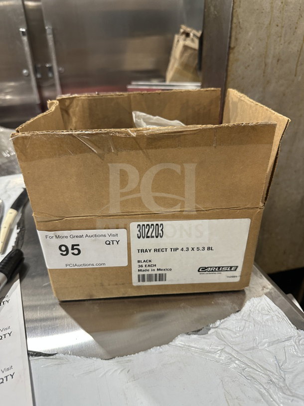 Box of 36 Carlisle Commercial Black Standard Tip Trays, Model 302203, brand new, with label showing size and origin.