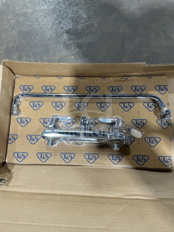 Brand new T&S commercial brass wall-mount workboard mixing faucet, 12" swing nozzle, in original packaging.