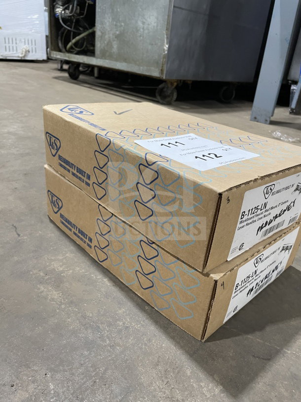 Two boxes of brand new T&S B1125LN commercial wall mounted workboard base faucets, labeled and sealed.