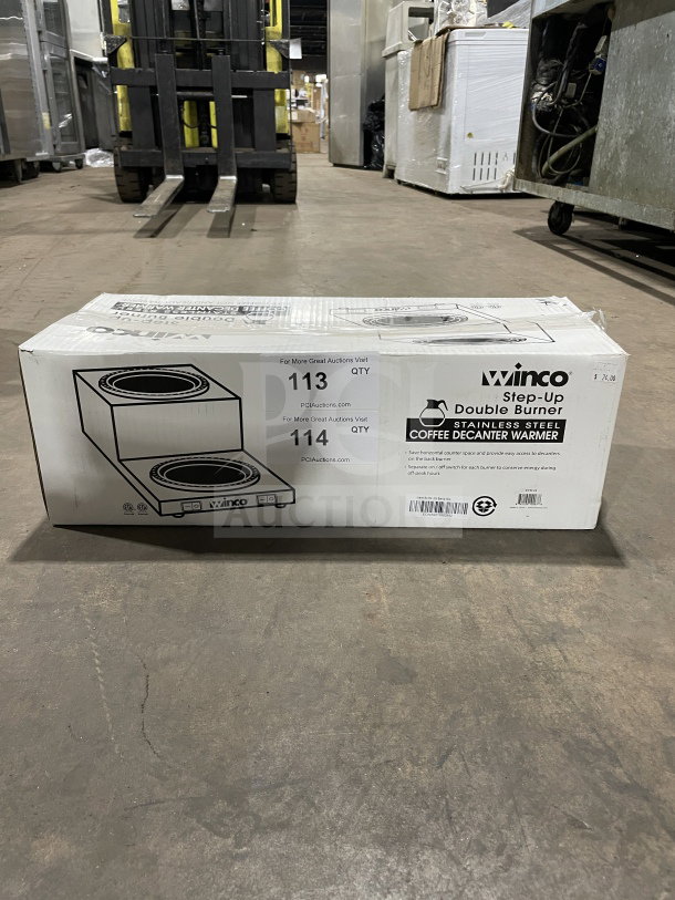 Boxed Winco ECW-25 stainless steel double coffee decanter warmer, brand new, in original packaging with product details visible.