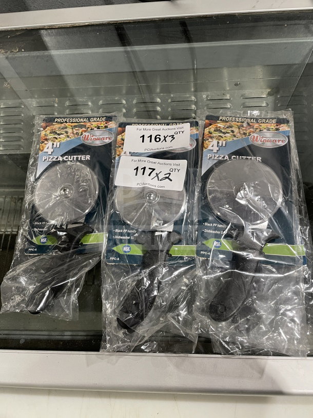 Brand new Winco 4" stainless steel pizza cutter, model PPC-4, with black plastic handle, in original packaging.