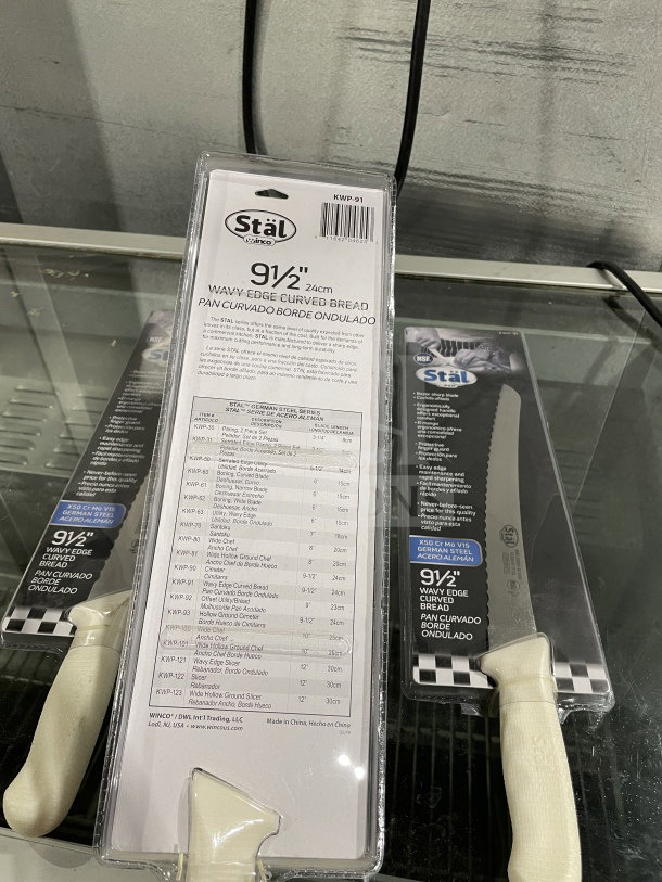 Brand new Winco Stal Series commercial bread knife, model KWP-91, 9.5-inch wavy edge, white PP handle, in packaging.