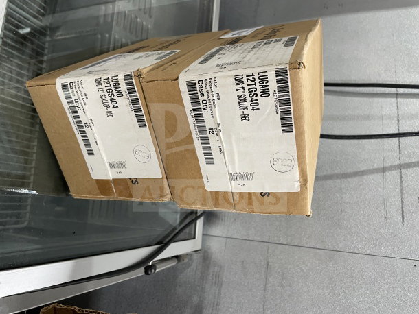 Two sealed boxes of Cambro Lugano Series red 12" scallop grip tongs, model 12TGS404, each containing 12 units.