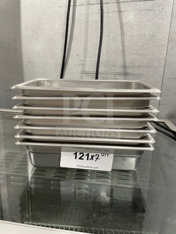 Brand new Thunder Group stainless steel steam table pans, model STPA3142. Includes 7 pans. Auction label shows quantity.