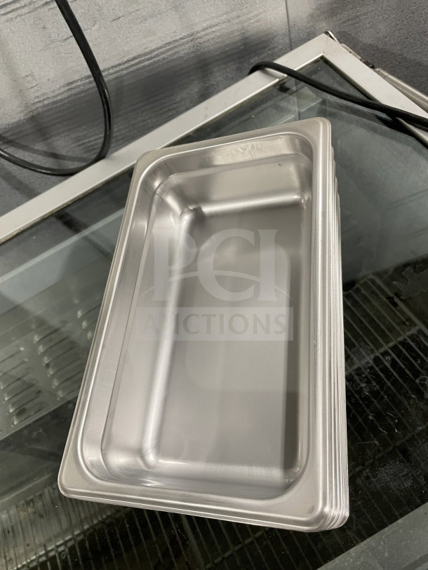 Brand new Thunder Group STPA3142 stainless steel steam table pan on glass surface.