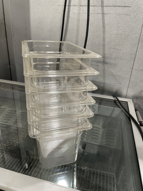 Brand new Thunder Group polycarbonate 1/4 6" food pans, model PLPA8146, stacked, clear, durable for commercial use.